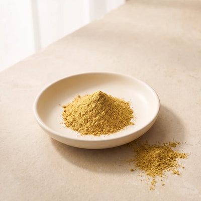 Golden berberine powder in an ivory ceramic dish.